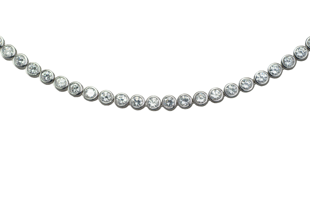 Sterling silver, rhodium plated, round brilliant cut cubic zirconia, 16" rub over line necklace.