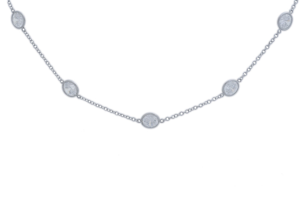 Sterling silver, rhodium plated, 7.5mm round, brilliant cut cubic zirconia, 16" spectacle set stationed necklace.