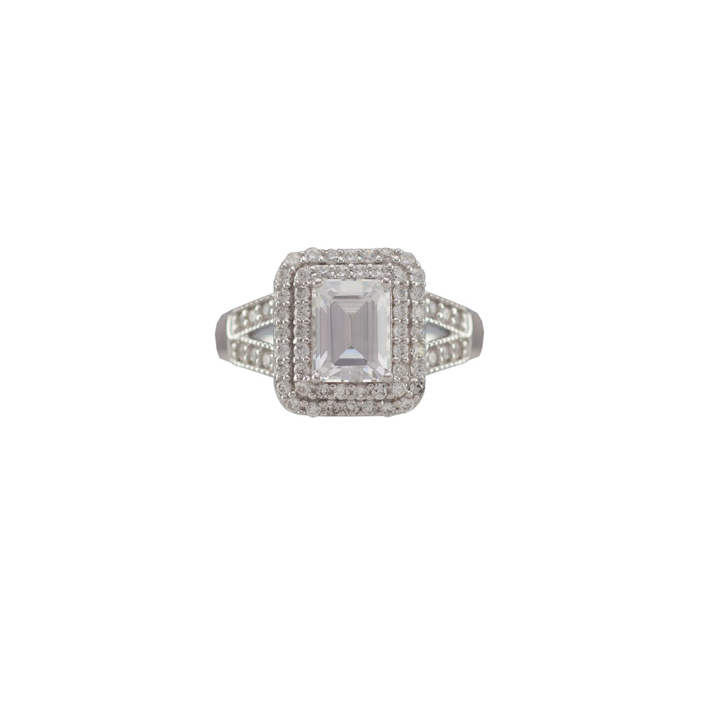 Sterling silver, rhodium plated, emerald cut cubic zirconia ring with double pave surround.