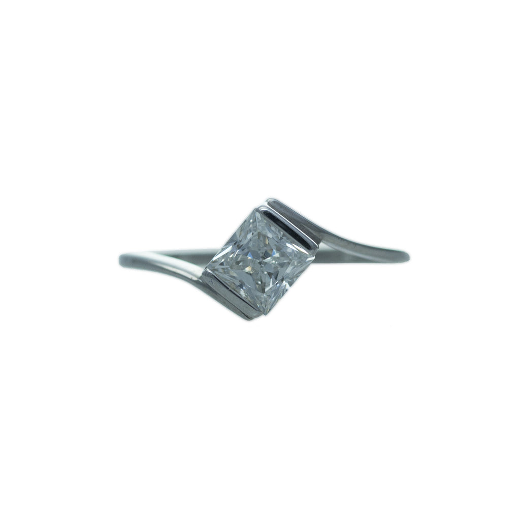 Sterling silver, rhodium plated, square princess cut, channel set, cubic zirconia twist ring. 