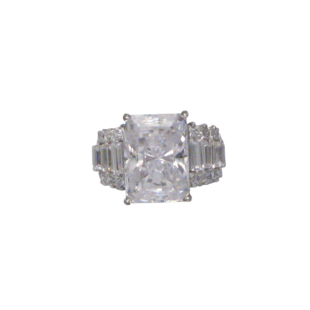 Sterling silver, rhodium plated, large emerald cut cubic zirconia ring with baguette and round brilliant cut cubic zirconia shoulders.