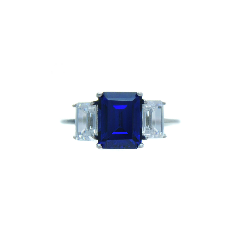 Sterling silver, rhodium plated, large tanzanite 7x9 emerald cut claw set ring with white emerald cut sides.