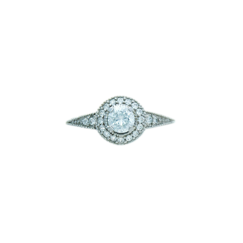 Sterling silver, rhodium plated, round brilliant cut cubic zirconia ring with pave surround and shoulders. 