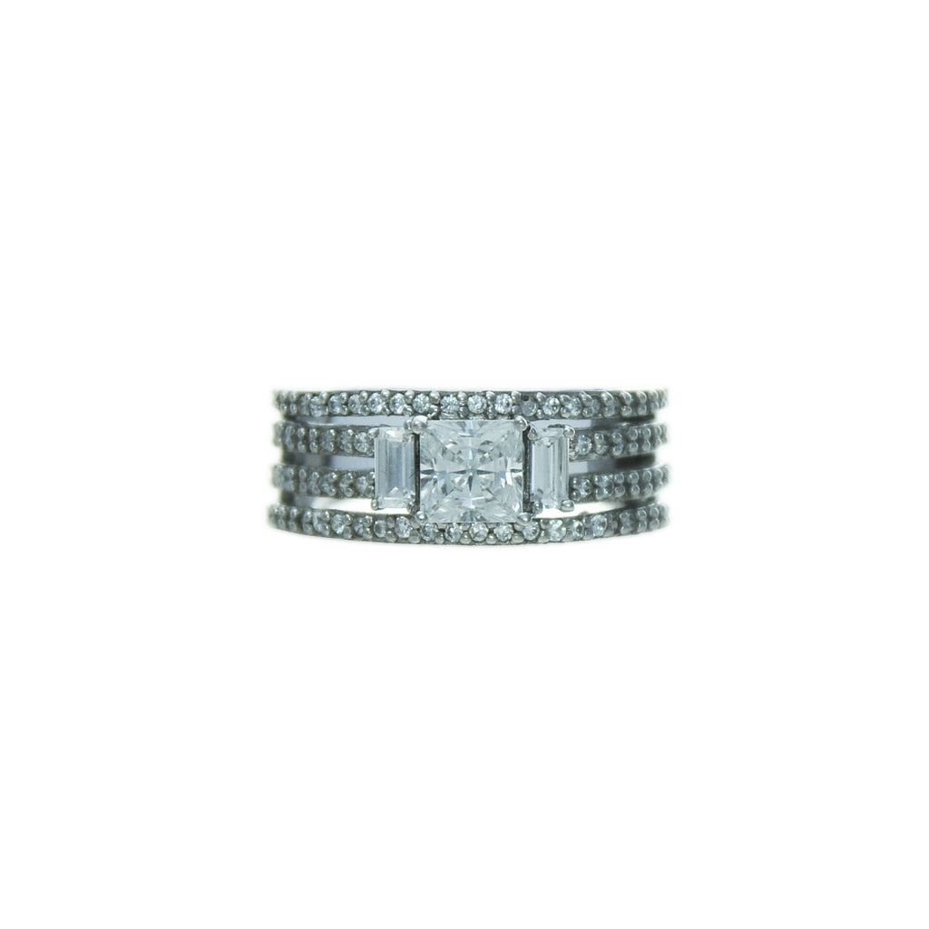Sterling silver, rhodium plated, square princess and baguette cut cubic zirconia claw set ring with four pave band shoulders.